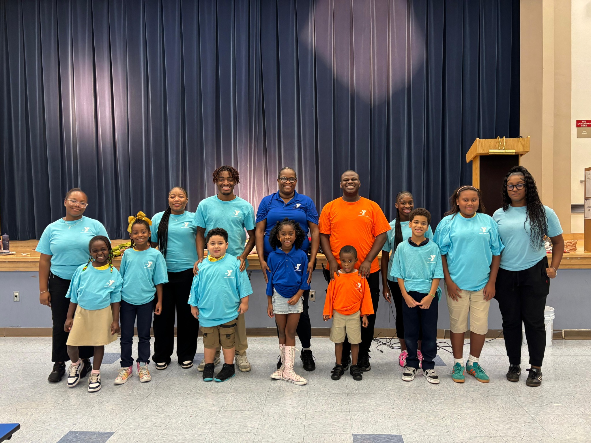 YMCA students and program staff gathered together at a school